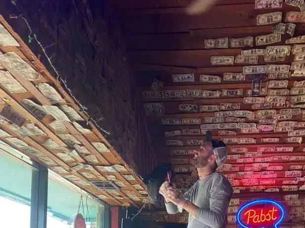Owners of a Georgia bar took down the dollar bills decorating its walls and ceiling to give to unemployed staffers in April